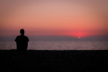 Naklejka na ściany i meble silhouette of man at sunset