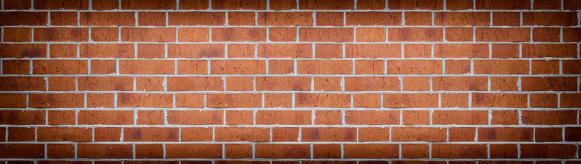 Wide red brick wall texture. Rough orange brickwork widescreen backdrop. Large long abstract background