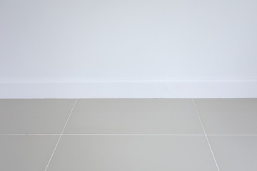 empty room interior, white mortar wall and clean tile floor in a new house