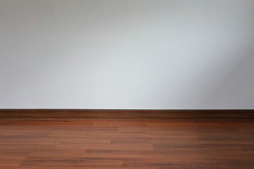 white wall and wood laminate floor in empty room