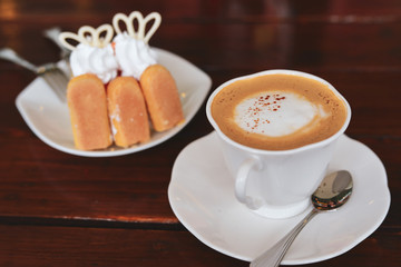 espresso hot coffee drink and orange cake put on breakfast table in the morning