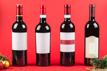 Bottles of red and white wine on a dark Burgundy background close-up. New year and Christmas.