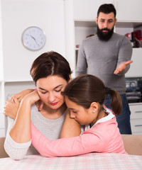 Father lecturing wife and daughter