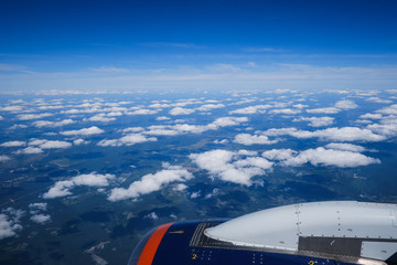 Clouds and sky as seen through window of an aircraft