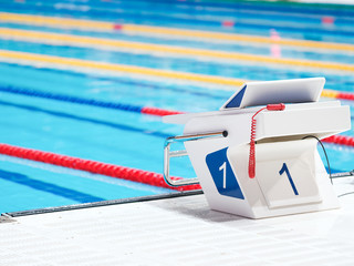 Swimming pool with starting block. Sport facility. Side view.