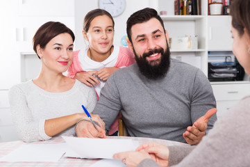 Parents signing property papers