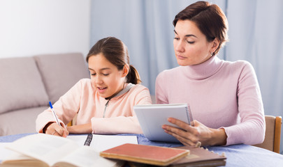 Mother and daughter doing school homework