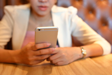 woman using mobile phone, image blurry used for business background