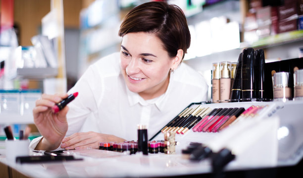 Customer browsing rows of cosmetic products