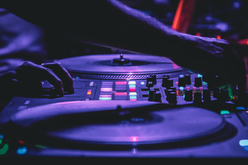 Fototapeta na wymiar DJ playing music at the club on vinyl players, selective focus, DJ hands