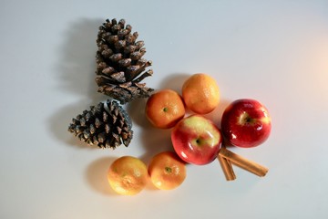 Tasty Christmas holiday fruit and spices on white background