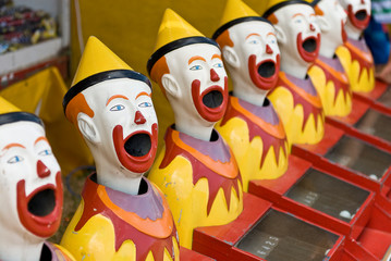 Brightly colored sideshow clowns at a circus..