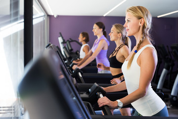 Fototapeta na wymiar Women running on treadmills