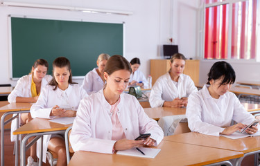Medical students using smartphones at class