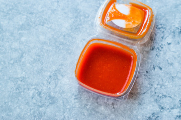Hot Spicy Red Sriracha Sauce in Plastic Box / Package or Container for Fast Food Ready to Eat.