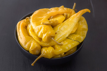 Fermented hot peppers on a black table - traditional Korean food. Close-up