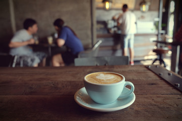cup of coffee on table in cafe - vintage style effect picture