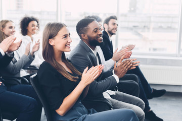 Group of business people applauding speaker after presentation - Powered by Adobe