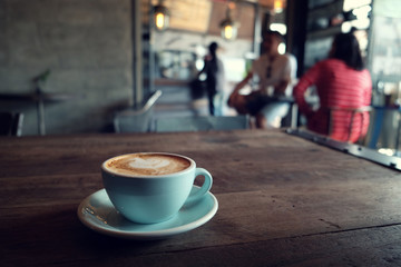 cup of coffee on table in cafe - vintage style effect picture