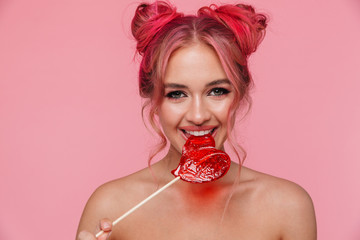 Portrait of beautiful shirtless young woman eating sweet lollipop