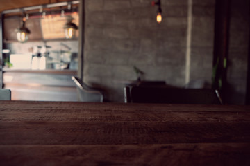 wood table on blur of cafe, coffee shop, bar, resturant, background - can used for display or montage your products