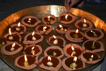 Giving flame to diyas on diwali festival in India