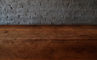 Empty top of wooden table or counter isolated on rustic brick Texture background. For product display