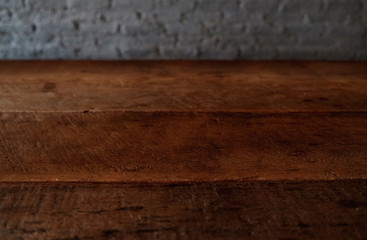 Empty top of wooden table or counter isolated on rustic brick Texture background. For product display