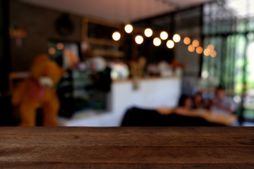 wood table on blur of cafe, coffee shop, bar, resturant, background - can used for display or montage your products