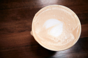 top view fresh coffee with latte art heart on a dark wooden background