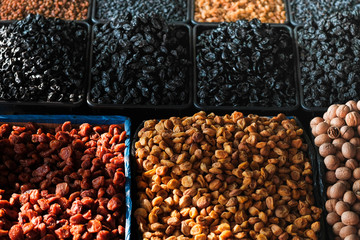 Dried berries on the counter. Raisins, dried apricots, prunes. Vegan food