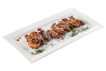 Fried Chicken Wings with sesame seeds on white plate isolated on white background