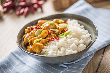 Chicken curry rice chili and young onion in bowl