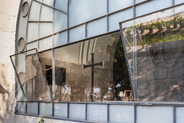 View of a large metallic black cross through the window of Dominus Flevit Church on the Mount Eleon - Mount of Olives in East Jerusalem in Israel