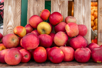 Naklejka na ściany i meble fresh ripe organic apples on a wooden background on a street farm market