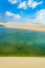 Tourist enjoying alone large natural pool in brazilian oasis