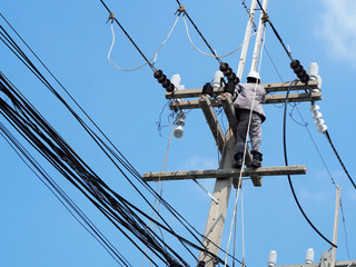 electrician man working at height and dangerous ,high voltage power line maintenance