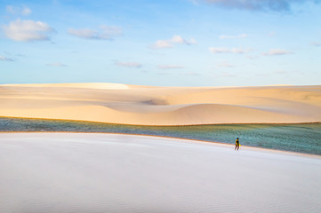 Walking through a oasis of white dunes in Brazil