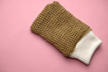 jute loofah glove  top view on a pink background, eco friendly lifestyle concept