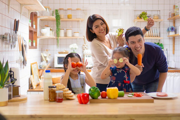 mother and daughter preparing food in kitchen