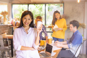 Beautiful woman standing front of meeting group 