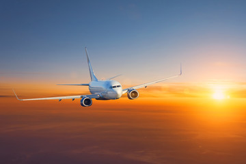 Fototapeta na wymiar Airplane in the morning sky at sunrise.