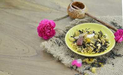 Herbal tea on plate on wooden background