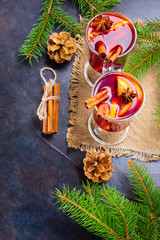 Mulled wine in glass mug with spices. Glasses of mulled wine with cinnamon, anise and fir tree branches. Winter Christmas drink. Top view
