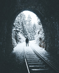 Person standing at the end of an Train tunnel