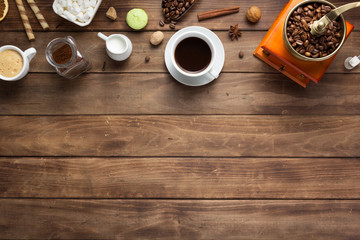 cup of coffee and beans on wooden background