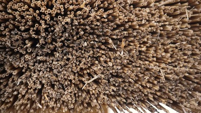 The thatch roofing, reed roof on the house. Natural building materials.