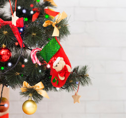 Christmas sock for toddler gift on decorated holiday tree