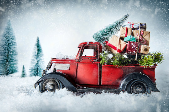Festive red vintage truck with Christmas gifts