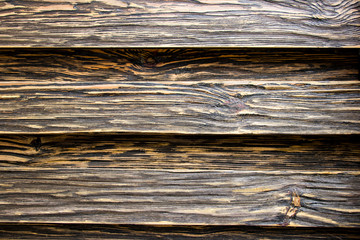 Fototapeta premium Aged wood texture. Boards are black and brown. Artificially aged wood. Deep texture. The concept of an old tree.